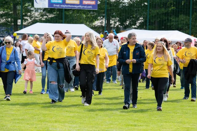 Daniel O'Donnell surrounded by carers as they start their lap at the Donegal Relay For Life Opening at the ATU Letterkenny in 2024.