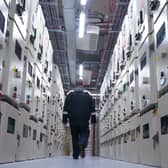 A man seen from behind walking inside data centre