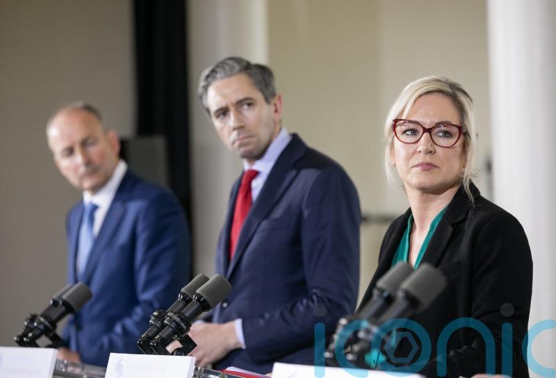 ‘Pantomime’ erupts in Dail as Simon Harris holds up graphic of Michelle O’Neill